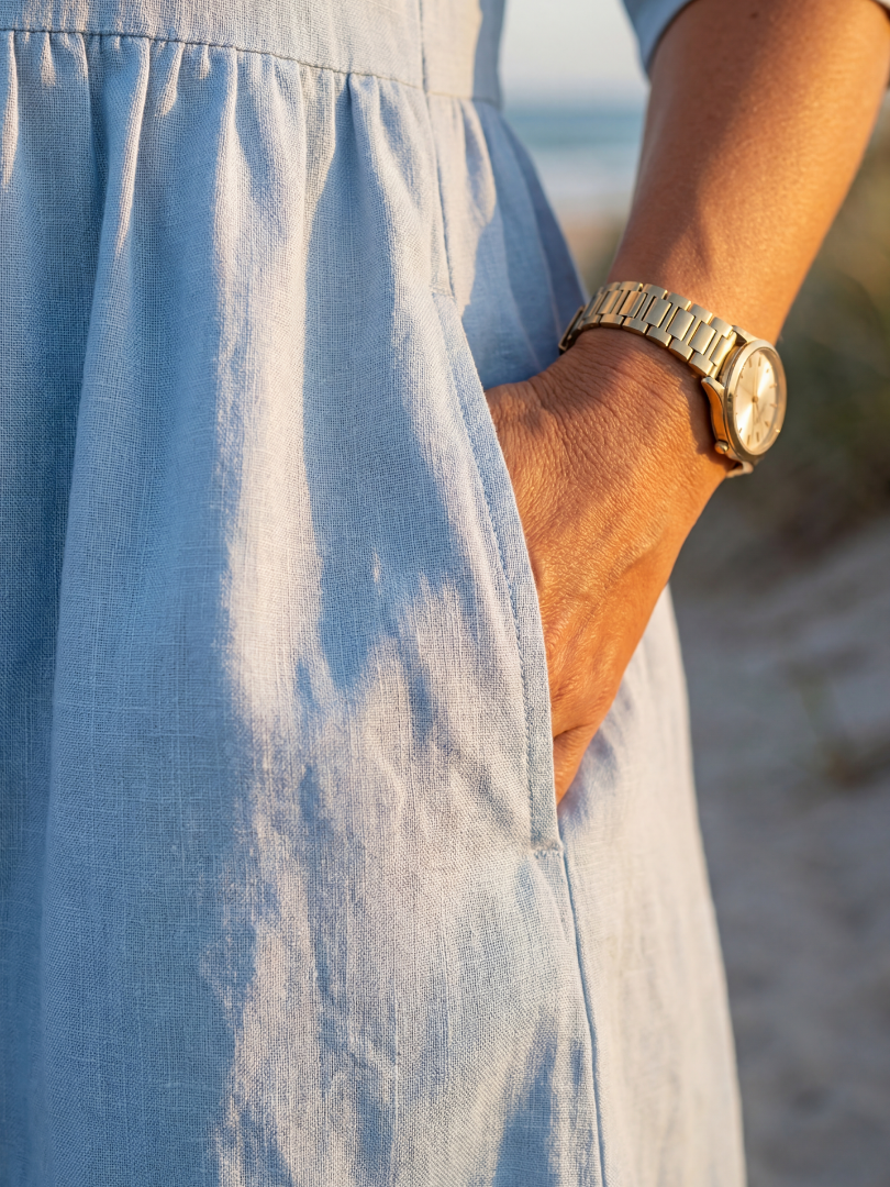 Flowy blue midi dress for women, elegant and comfortable with a round neck and half sleeves. Summer style.