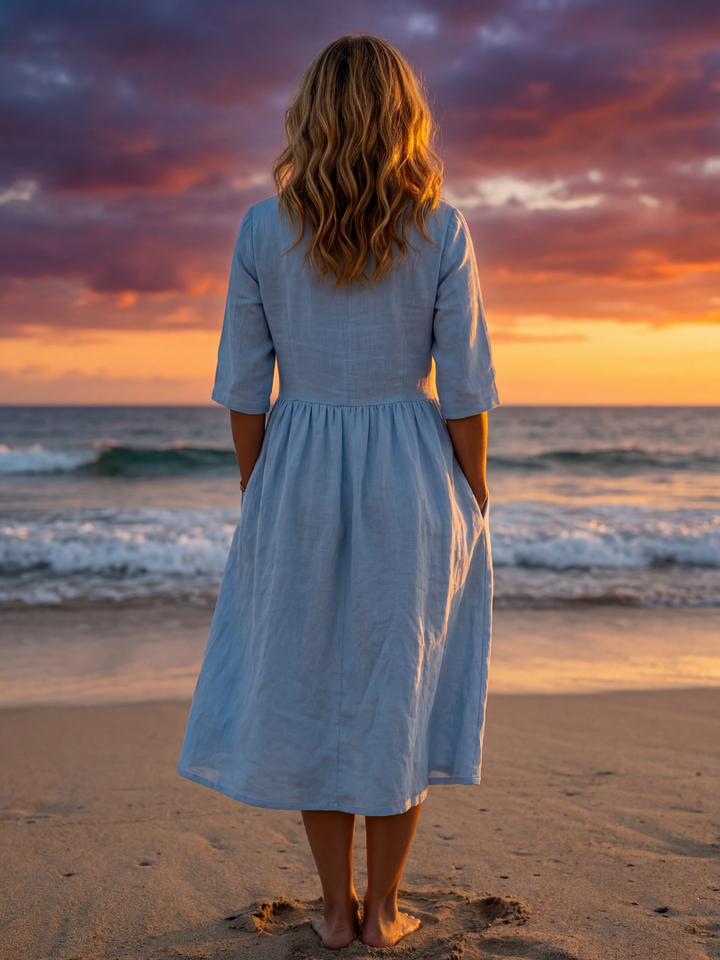 Stylish women's blue flowy midi dress, half sleeve, round neck. Elegant and comfortable for summer wear.
