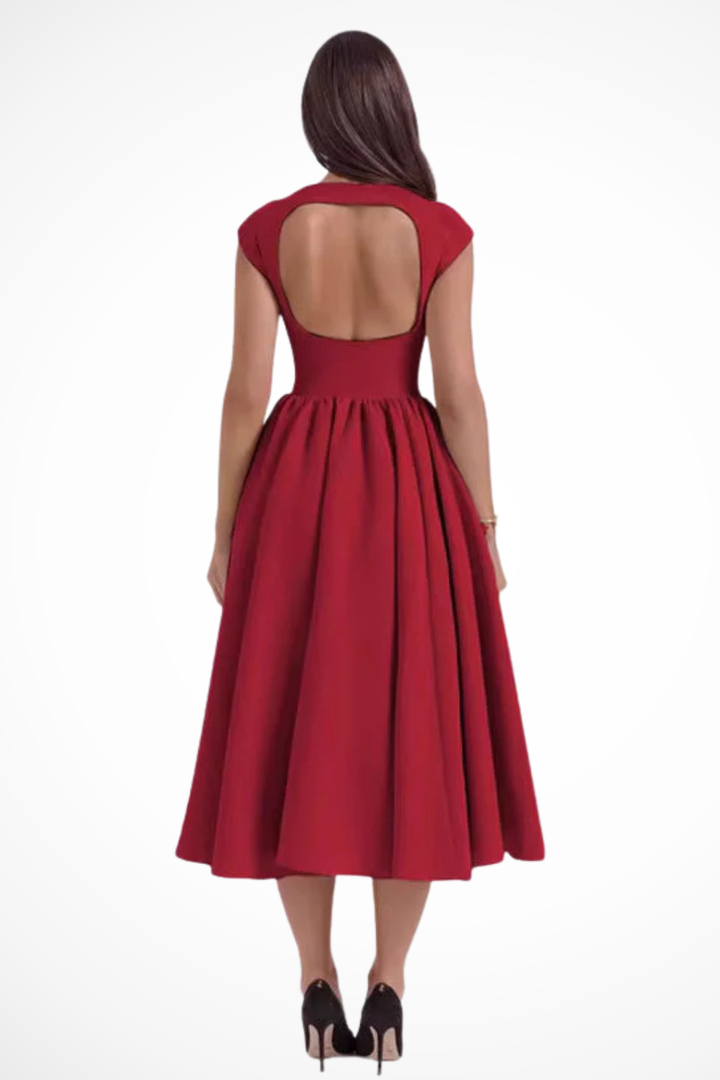 Tailored black midi dress with boat neck & cap sleeves, classic, versatile formal wear option for women.