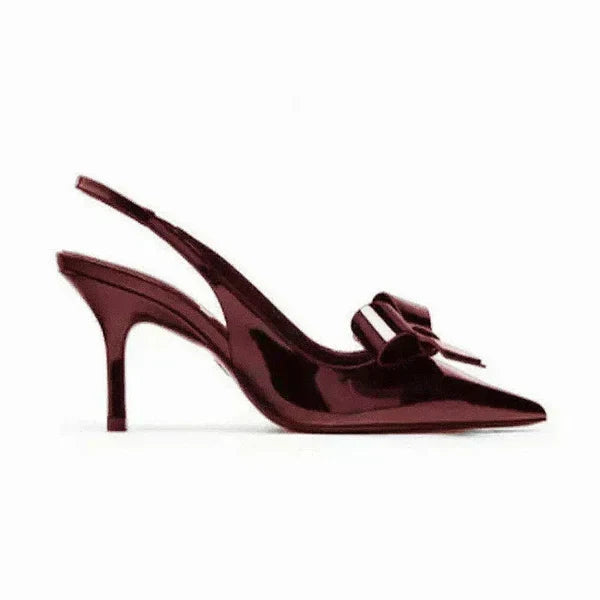 Fashionable women's pointed toe heels featuring a delicate bow and secure slingback design. Elegant stiletto.