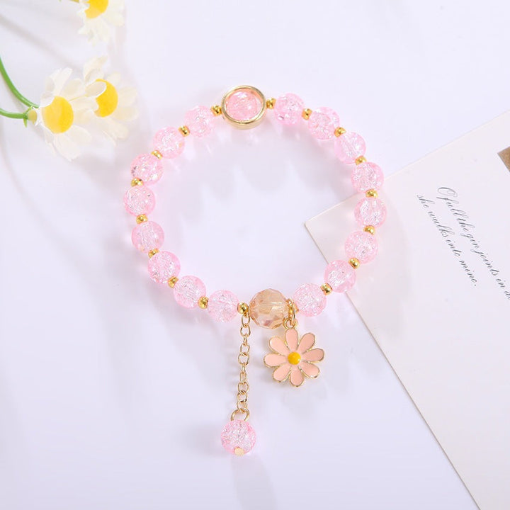 Elegant women's bracelet with a sparkling flower pendant & colorful glass beads. Perfect fashion accessory.