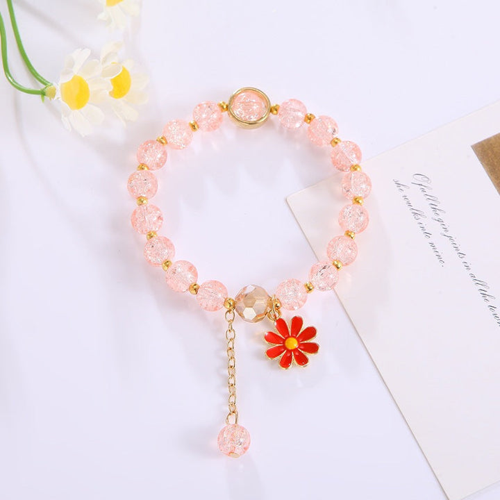 Elegant women's accessory: A colorful glass bead bracelet with a striking flower pendant, perfect for gifting.