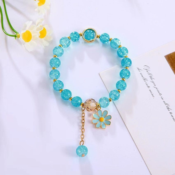 Women's sparkling bead bracelet, adorned with a graceful flower pendant. Adds a touch of glamour.
