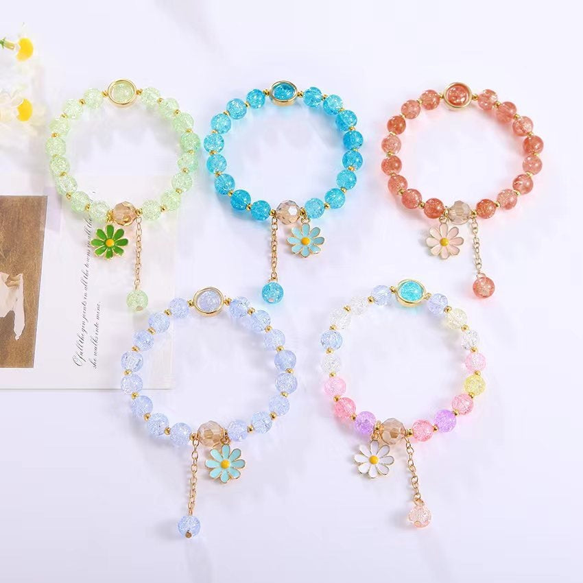 Women's fashion bracelet featuring a beautiful flower pendant & shiny glass beads. Ideal elegant jewelry gift.