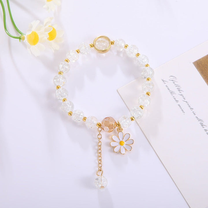 Fashionable women's jewelry: elegant bracelet with a unique flower pendant & shimmering glass beads.