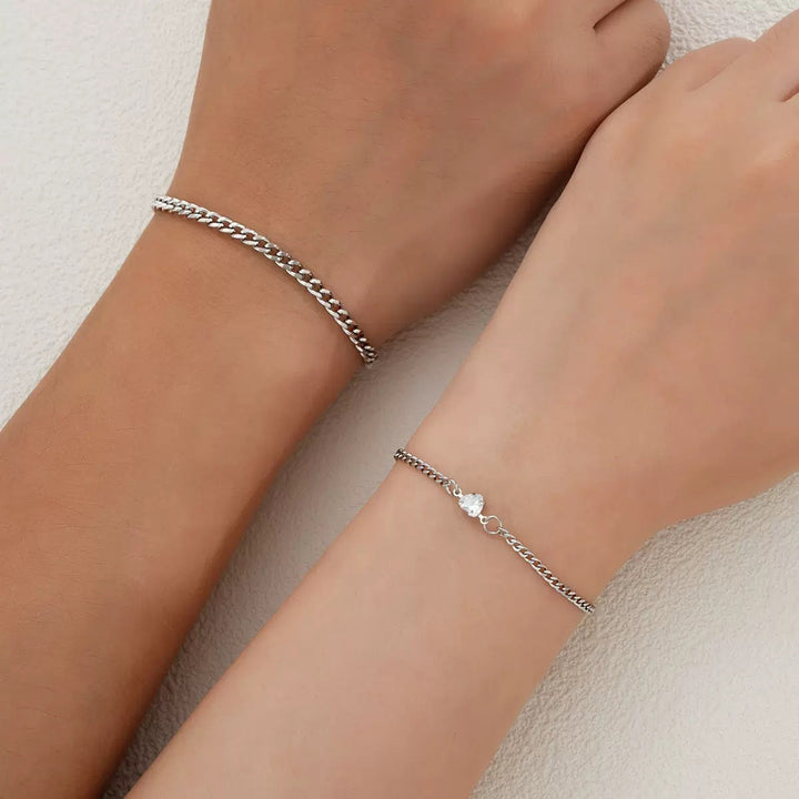 Women's braided chain bracelet featuring delicate silver and gold links, elegant and versatile jewelry.