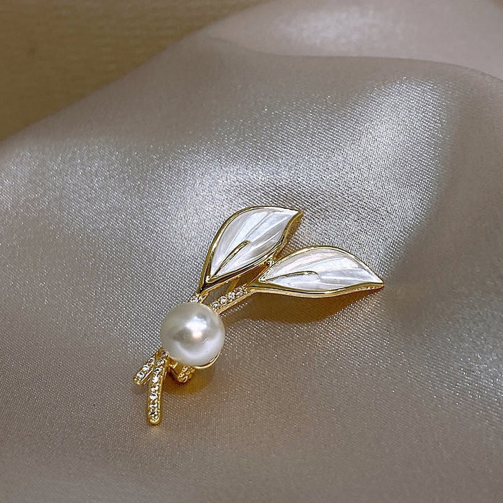 Sparkling rhinestone branch brooch with white pearls, an elegant women's fashion accessory and jewelry piece.