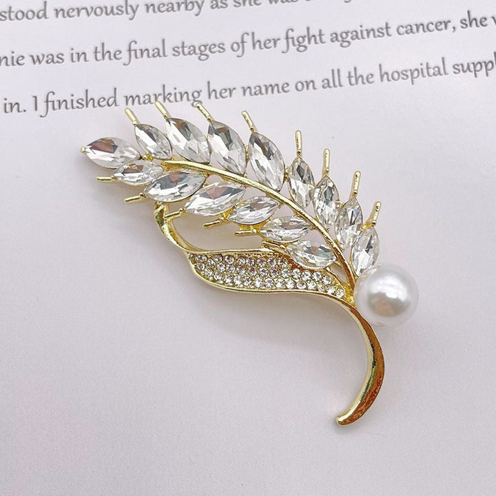 Exquisite women's leaf brooch pin, adorned with sparkling glitter stones and elegant pearls.
