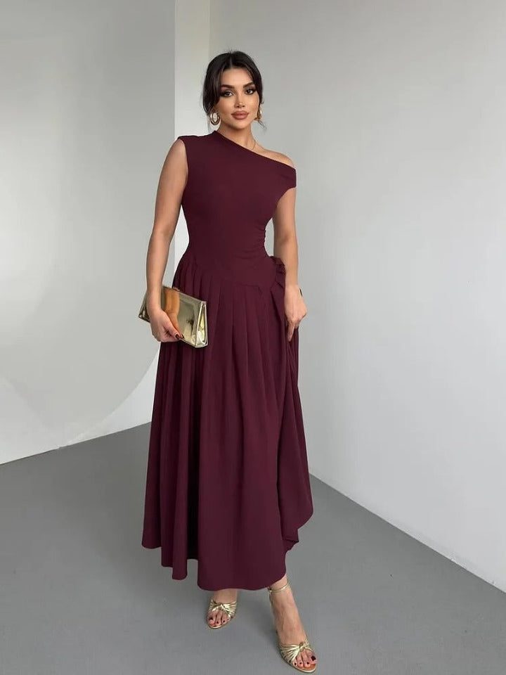 Women's long burgundy draped one-shoulder dress, featuring an elegant design for evening or formal events.