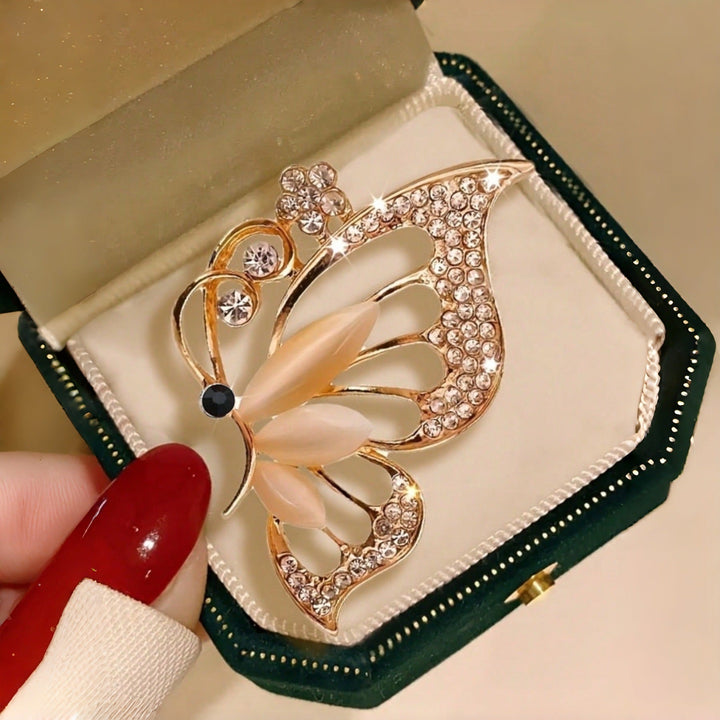 Fashionable women's butterfly brooch featuring delicate rhinestones, an ideal accessory for dresses.