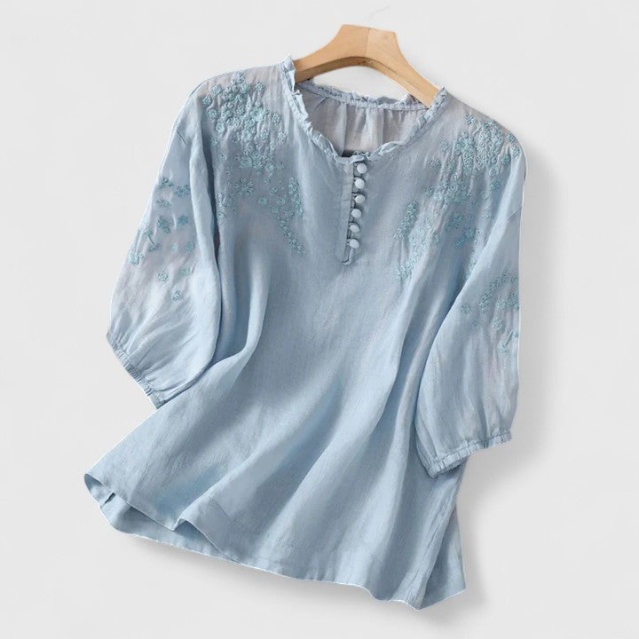 Chic women's button-front blouse, featuring elegant embroidery; ideal for a sophisticated look or casual chic style.