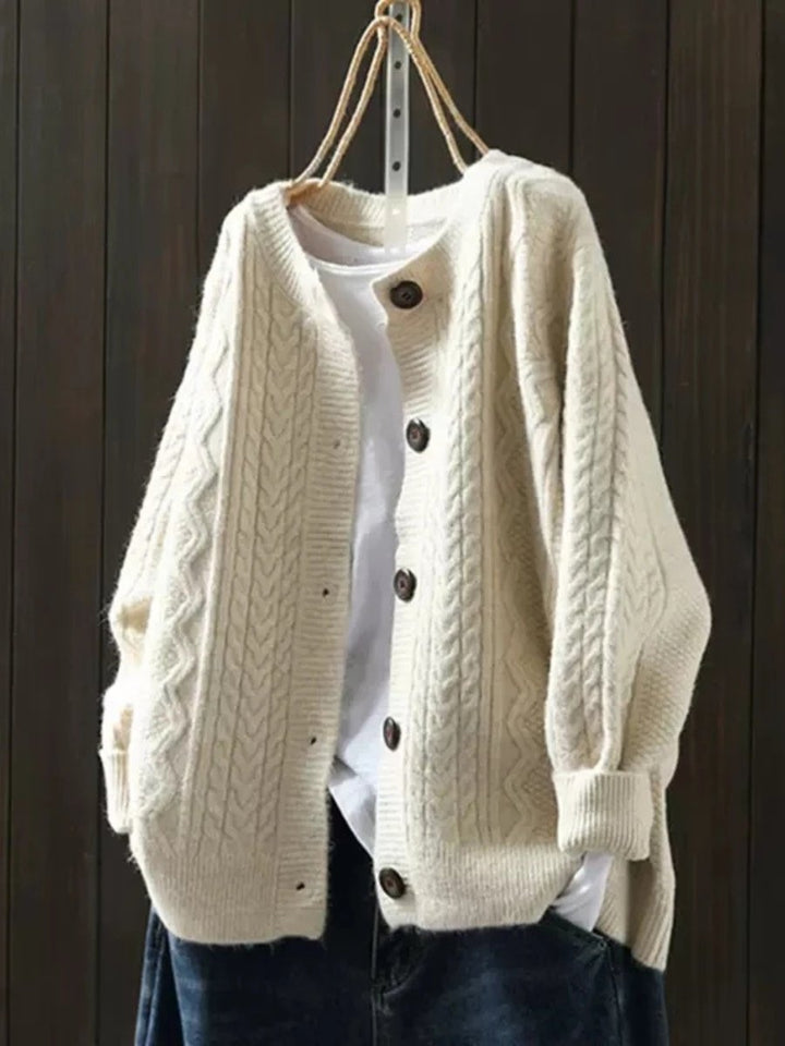 Cozy oversized cable-knit button-down cardigan for women, ideal for classic winter wear.