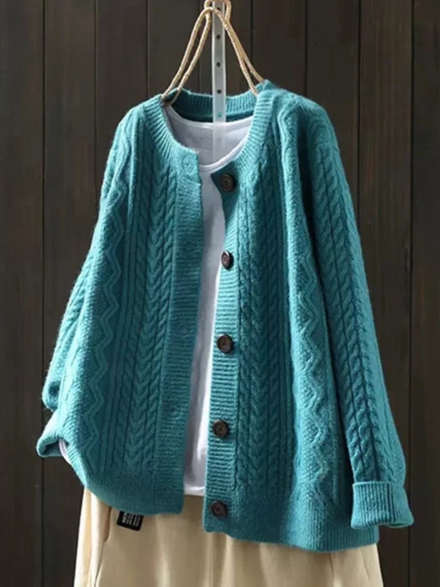 Women's elegant cable-knit button-down cardigan, featuring a soft, cozy knit for winter fashion.
