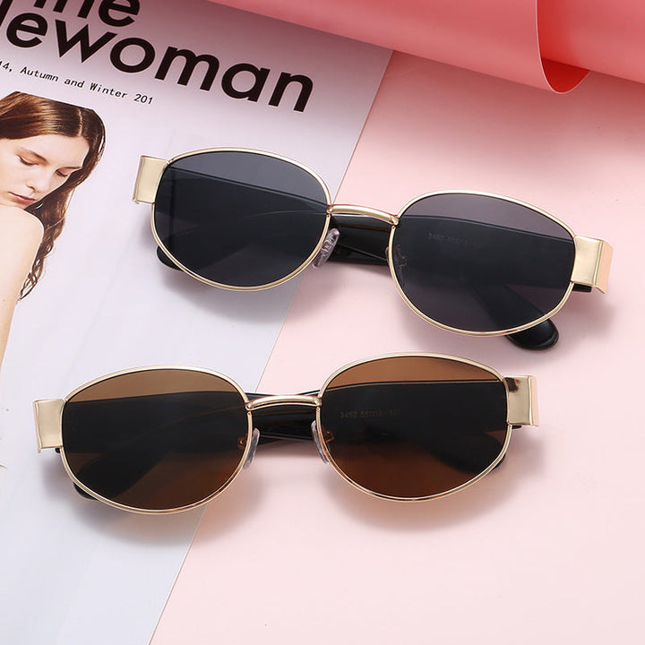 Elegant women's cat-eye sunglasses with UV protection & sleek metal frame. Fashionable eyewear accessory.