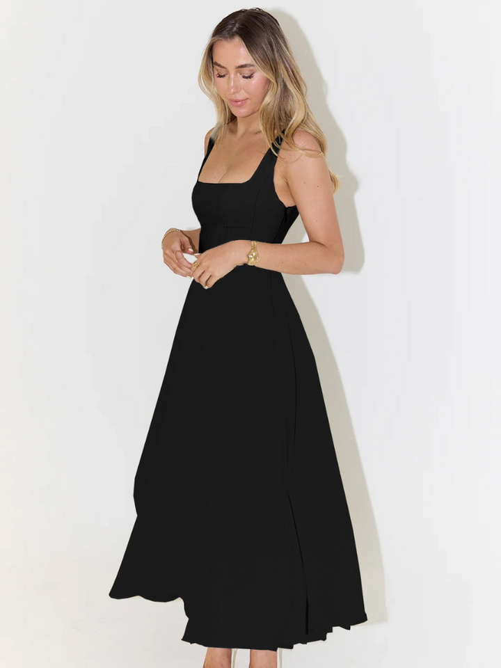 Close-up of the elegant fabric & flattering design of a women's chic midi dress, ideal for occasions.