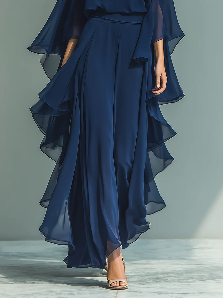 Stylish women's chiffon two-piece outfit in motion, featuring wide leg trousers & ruffled top for elegant party wear.