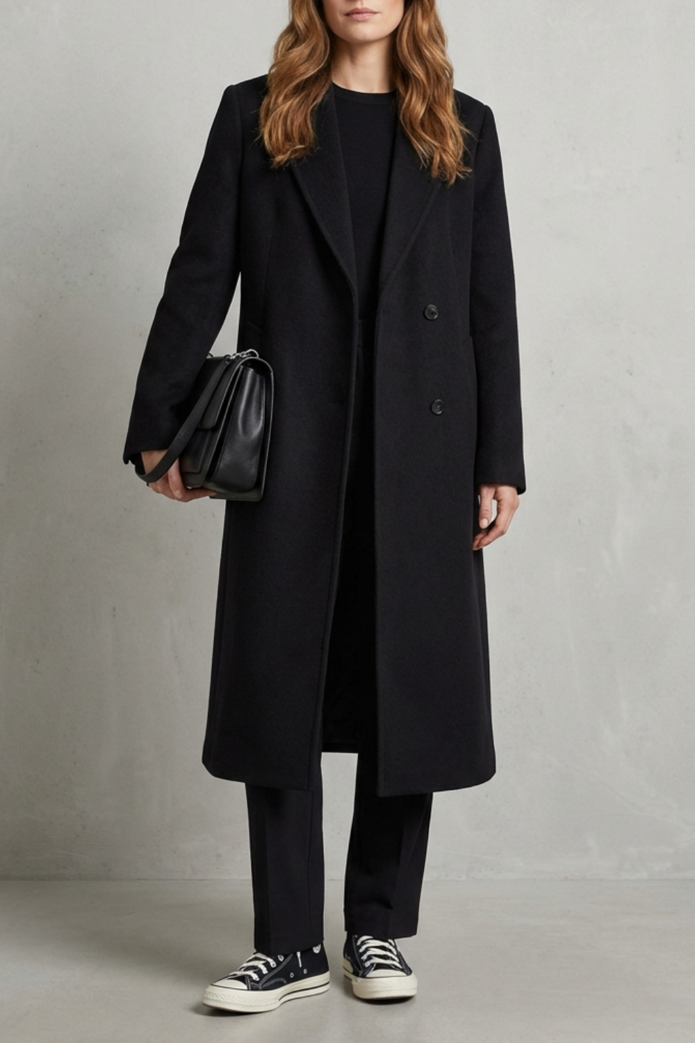 Elegant women's classic black herringbone overcoat, tailored for timeless style and winter fashion.