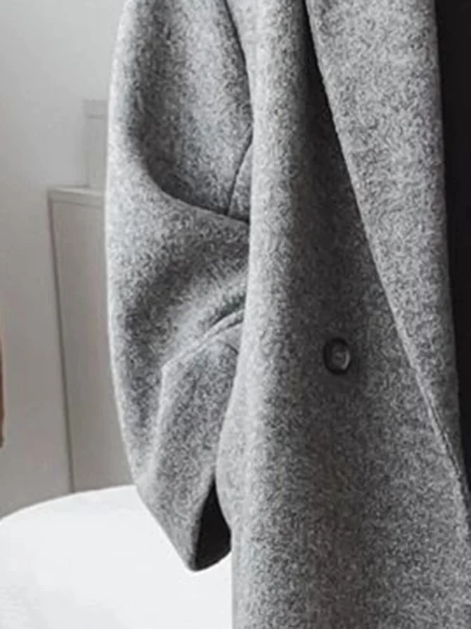 Stylish women's grey tailored long overcoat, perfect for elegant autumn & winter fashion. Warm & versatile.