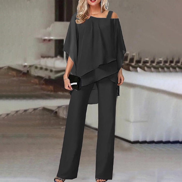 Elegant women's cold shoulder jumpsuit with flowy fabric, perfect for evening wear or stylish casual outings.