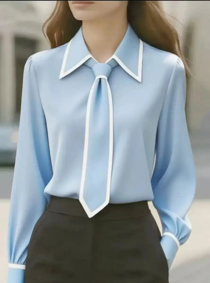 Women's button-down blouse with striking contrast details, a chic tie neck, and an elegant oversized collar.