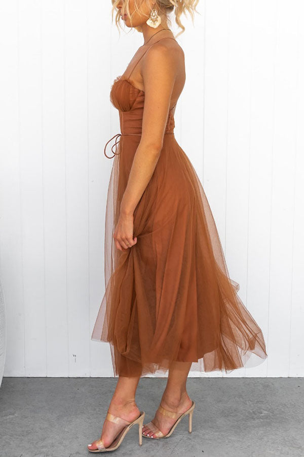 Stylish women's formal dress featuring a structured corset and flowing tulle skirt.