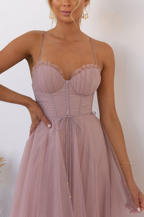 Feminine occasion wear: a stunning midi dress with elegant corset and full tulle skirt.