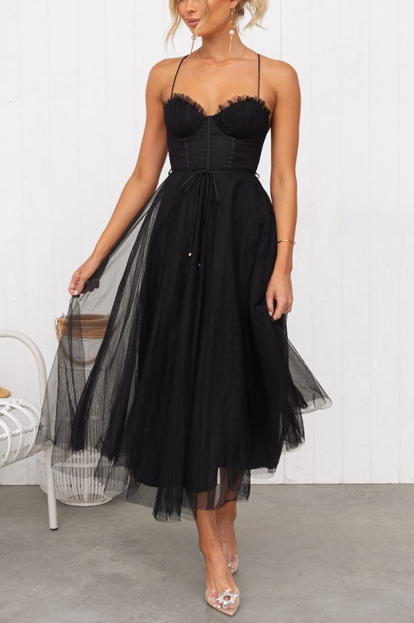 Formal women's evening gown; a chic corset and layered tulle midi skirt.