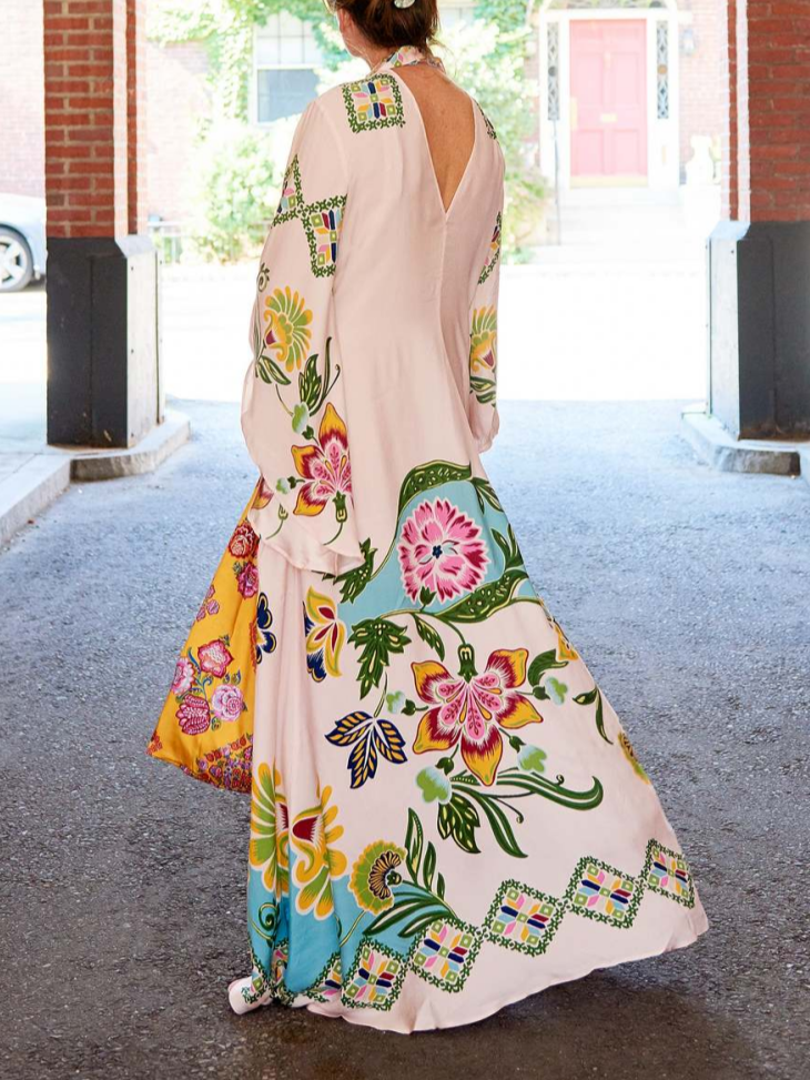 Flowy cream floral maxi dress for women, featuring long sleeves & an elegant design for versatile wear.