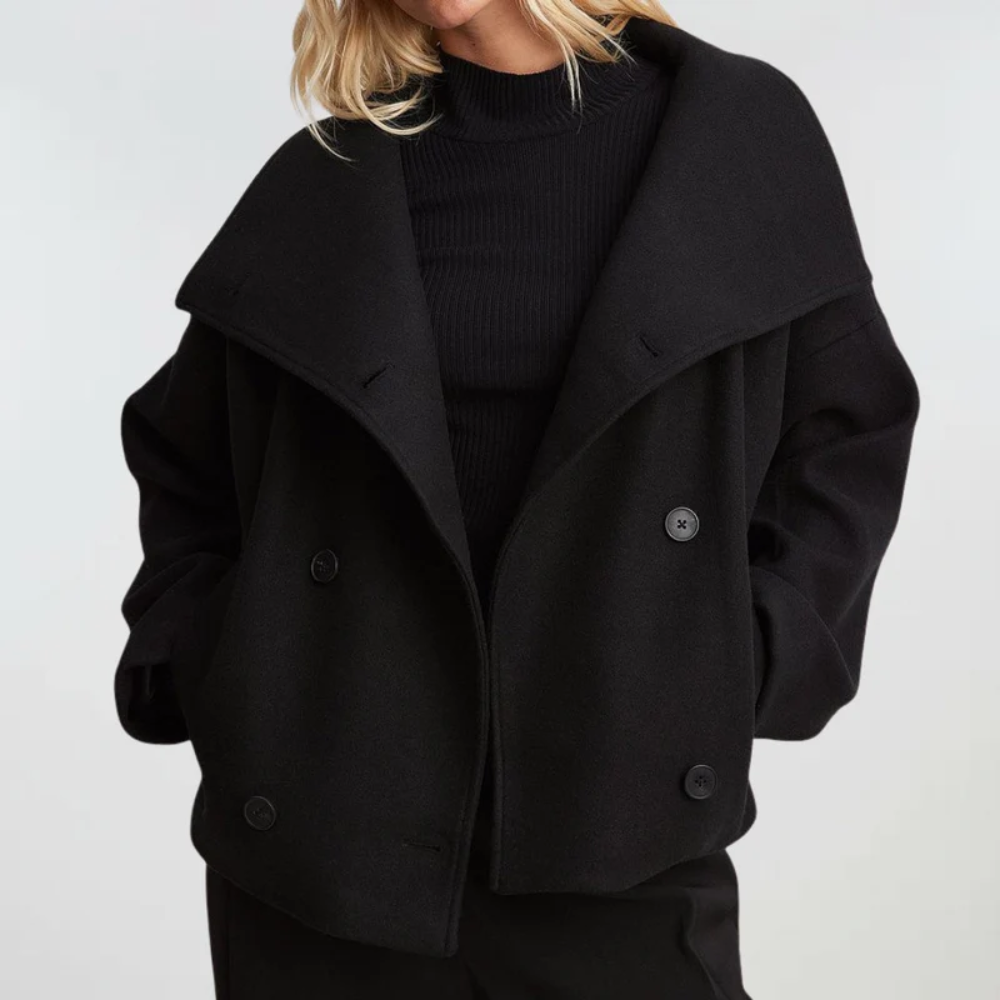 Elegant women's cropped double-breasted coat, perfect for fall fashion outerwear. Chic structured jacket.