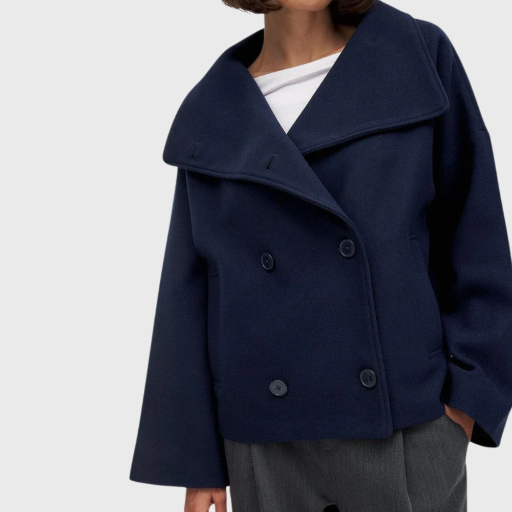 Stylish women's cropped double-breasted winter coat. A chic fall jacket and fashion outerwear piece.