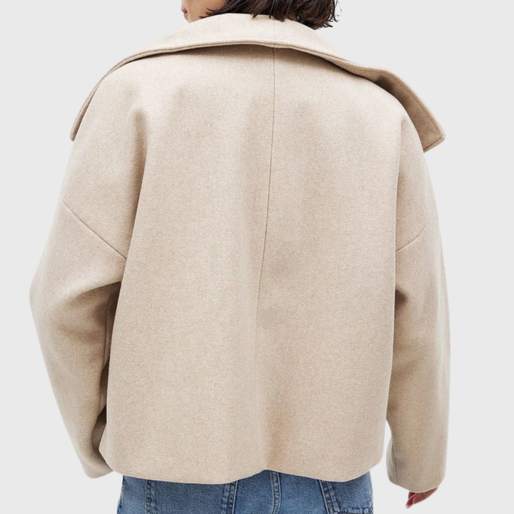 Classic women's cropped double-breasted jacket. Elegant winter coat, a stylish piece of fall outerwear.
