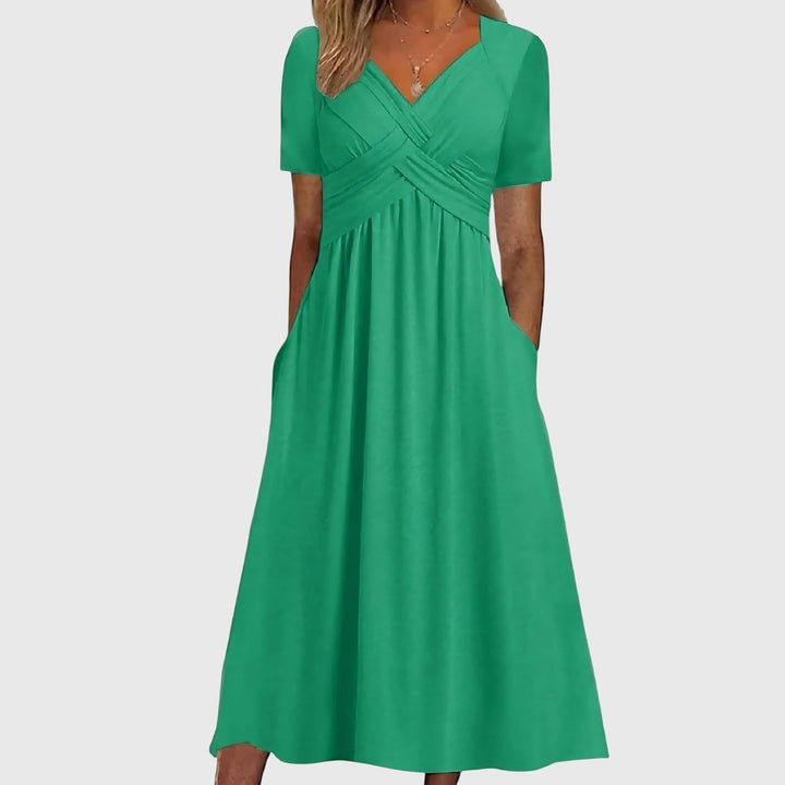 Elegant women's cross-front A-line midi dress with tummy control, short sleeves, and pockets for versatile wear.