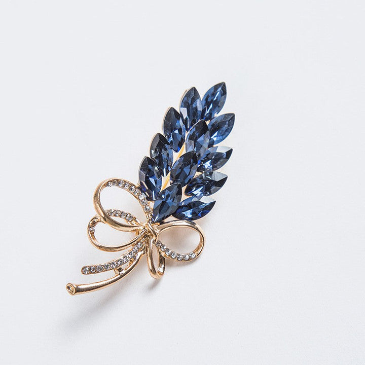 Sparkling crystal leaf brooch pin for women. Stylish bow design, an elegant accessory and fashion gift for her.