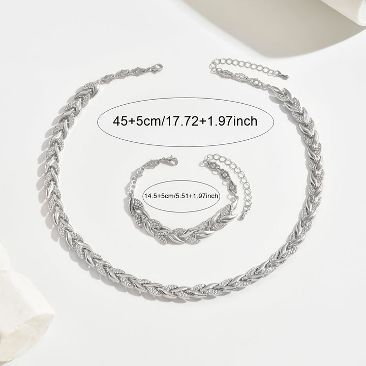 Matching crystal leaf jewelry set for women, including a sparkling necklace and a delicate bracelet.