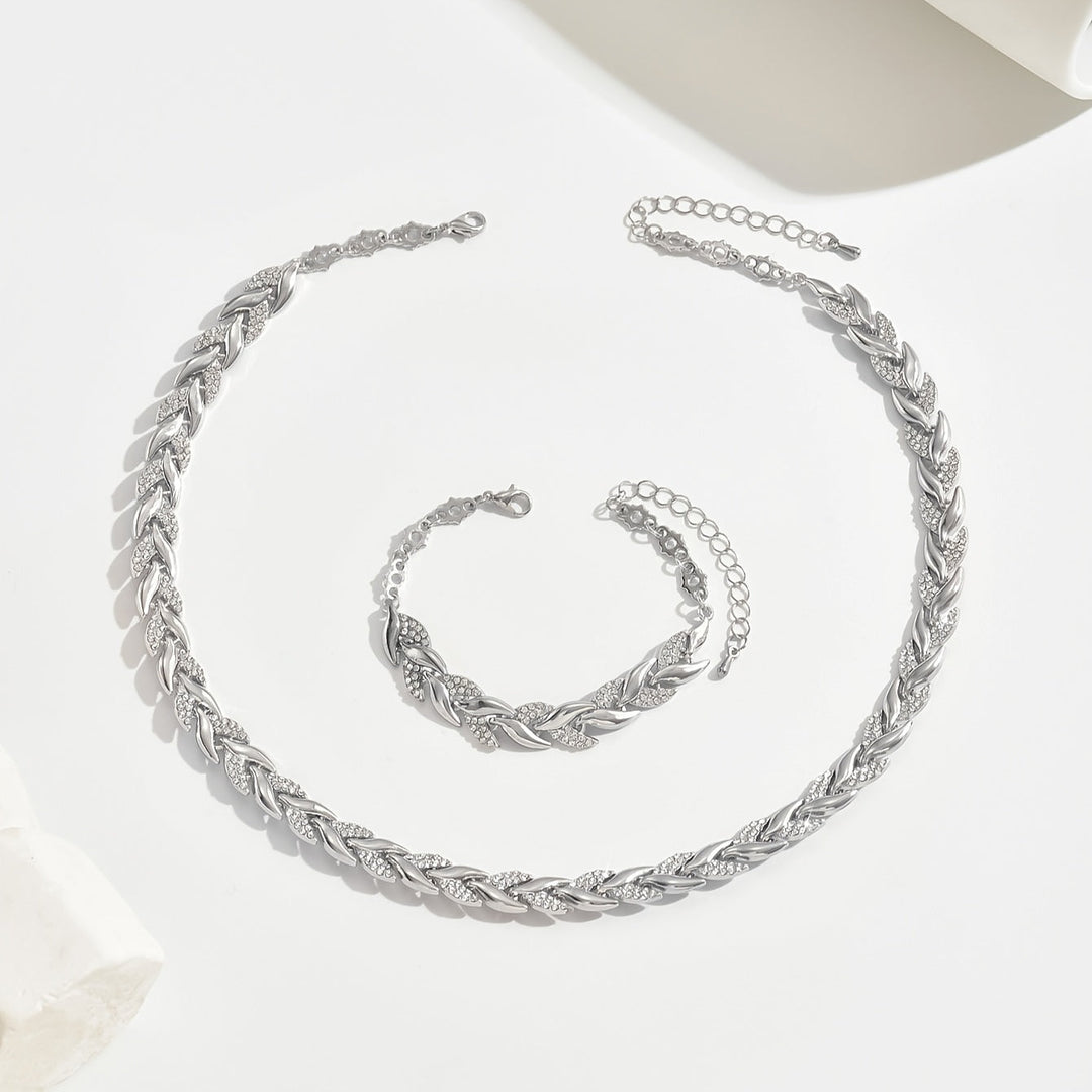 Sophisticated women's crystal leaf necklace & bracelet set. Silver-toned, elegant accessory for any occasion.