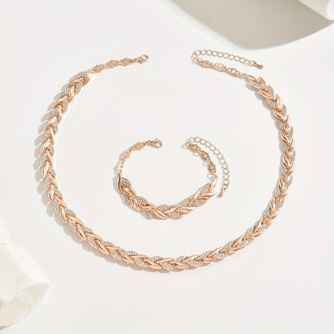 Sparkling crystal leaf chain necklace and bracelet duo for women. Elegant fashion statement jewelry.