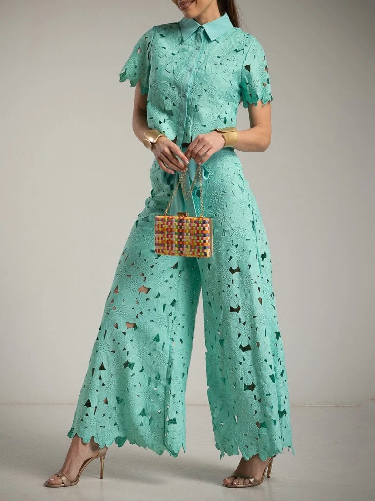 Flowy wide-leg trousers and delicate cutout lace top; a sophisticated women's two-piece elegant outfit.