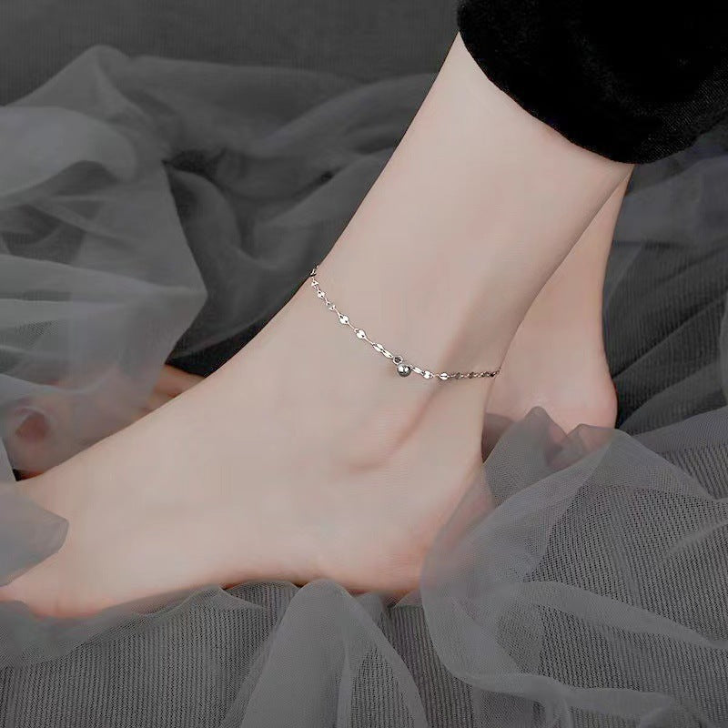 Delicate gold chain anklet with tiny heart charms for women. Adjustable elegant foot jewelry.