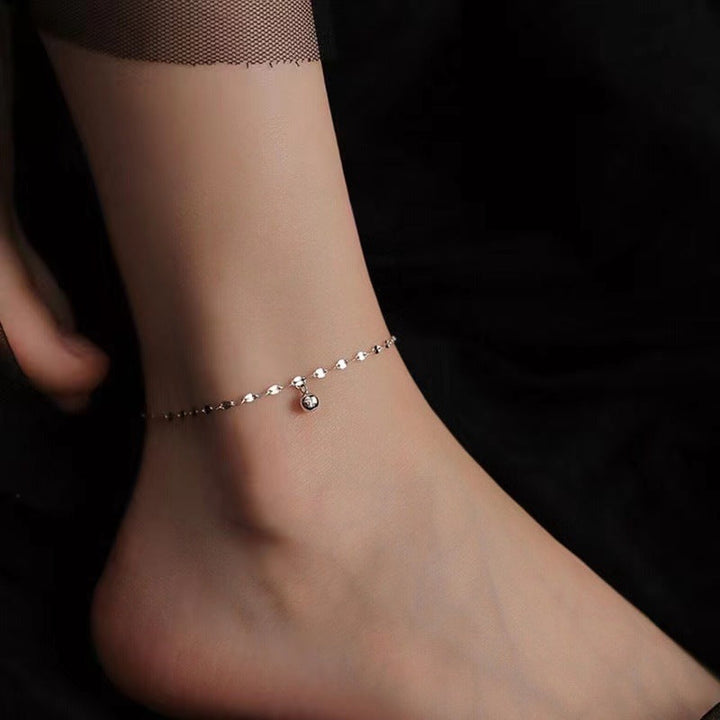 White gold finish women's dainty heart chain anklet. Adjustable, elegant foot accessory.