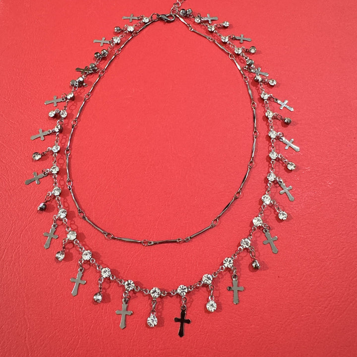Woman wearing an elegant double layer cross pendant necklace, a versatile and spiritual fashion accessory.