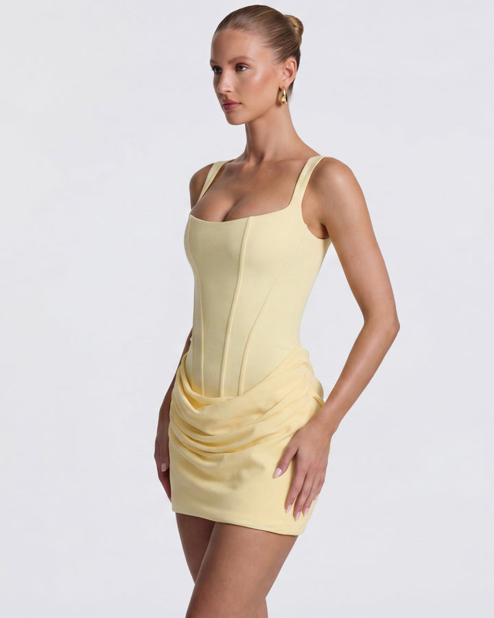 Sophisticated women's evening mini dress, elegantly draped, with a fitted corset silhouette.