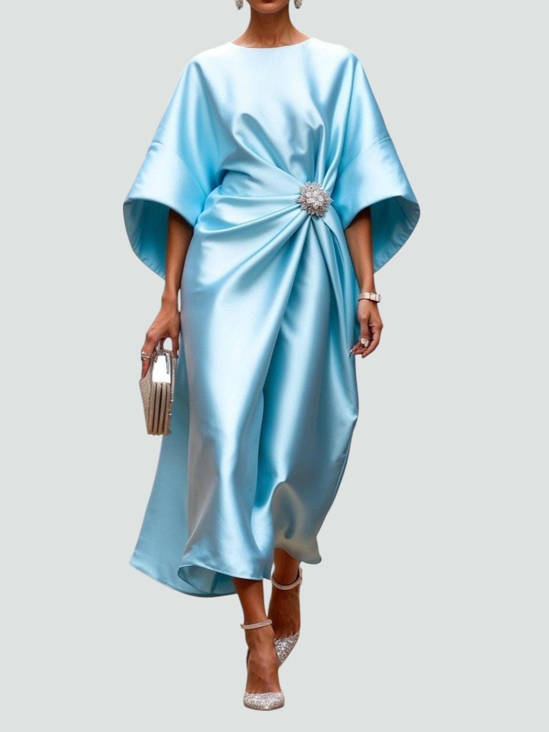 Sophisticated women's draped maxi dress featuring a chic brooch, suitable for formal events.