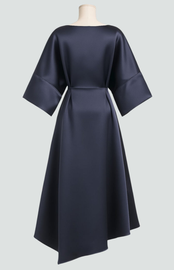 Sophisticated long women's dress, elegantly draped with a brooch, suitable for formal or evening events.