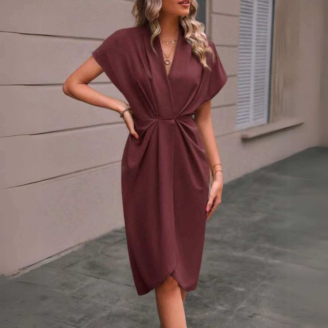 Elegant women's draped midi dress, flattering V-neck, cap sleeves & chic tulip hem, perfect for occasions.