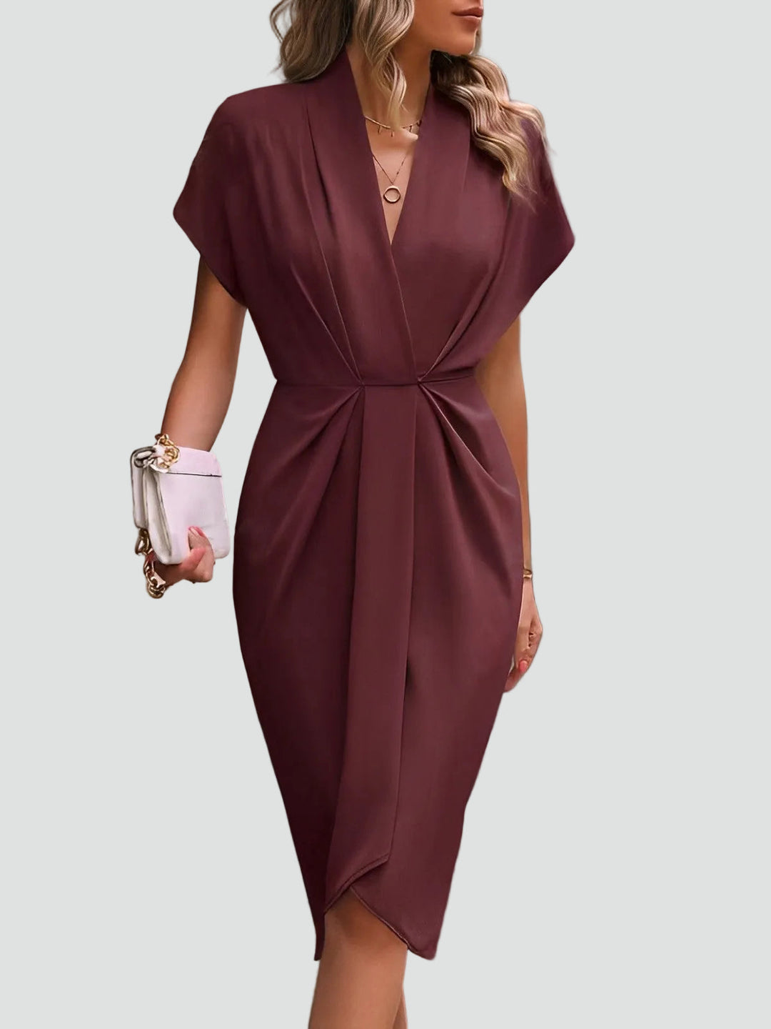 Close-up: Fashionable split & hem of an elegant women's draped midi dress. Formal evening wear.