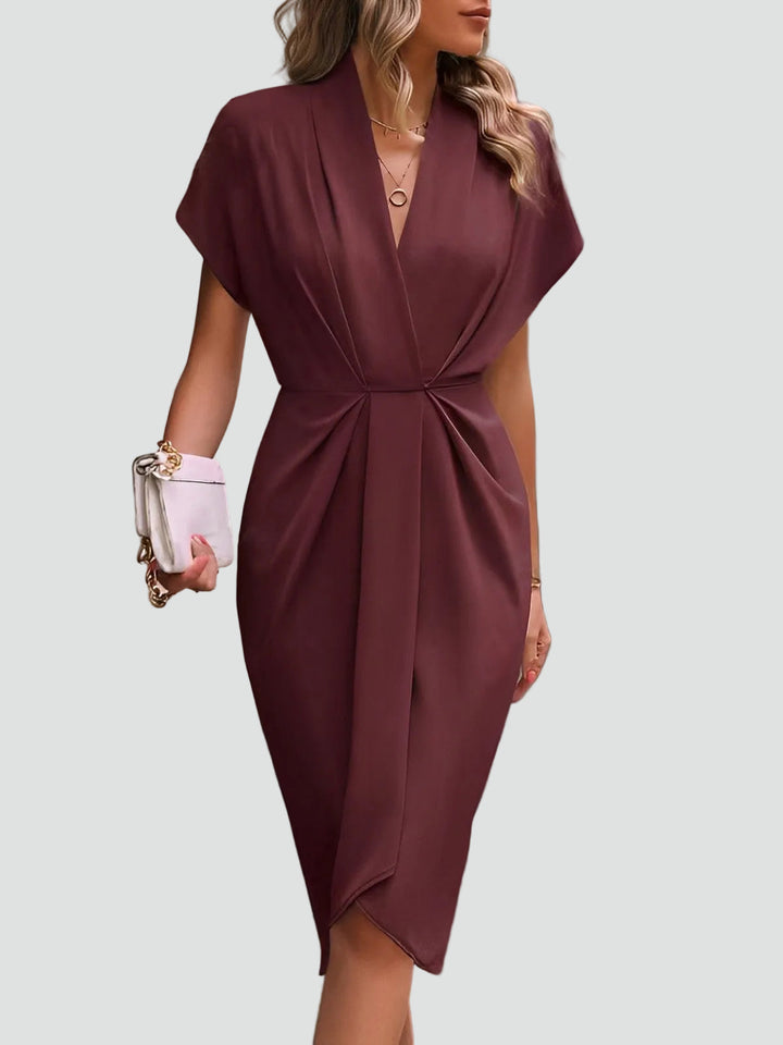 Close-up: Fashionable split & hem of an elegant women's draped midi dress. Formal evening wear.