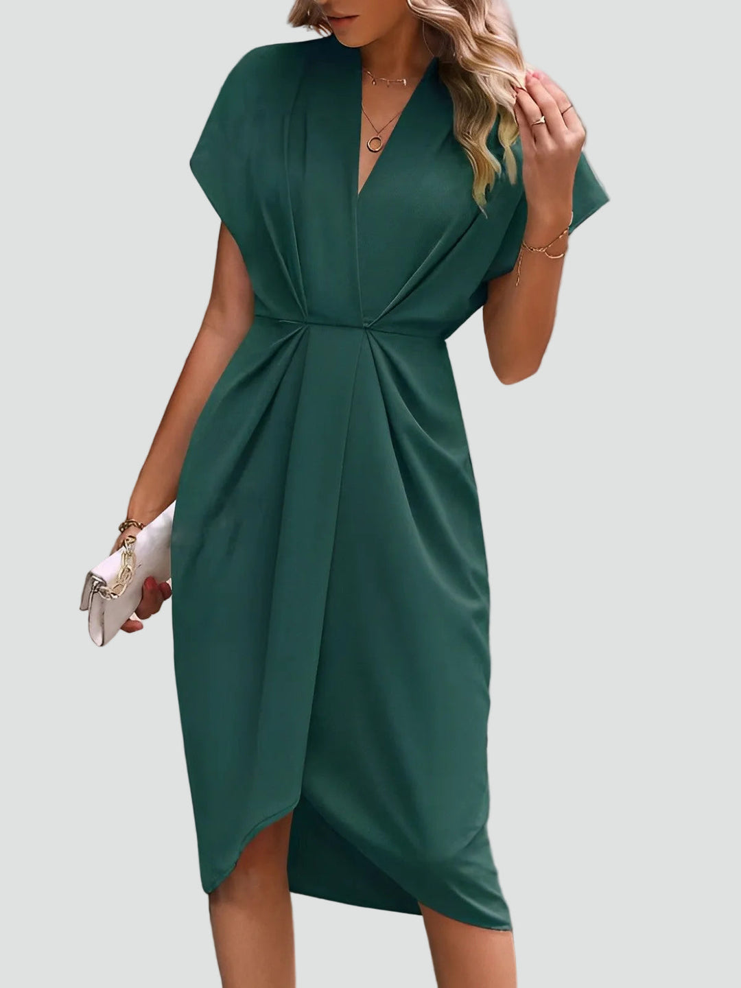 Close-up: Elegant V-neck and draped detail on a sophisticated women's midi occasion dress. Party wear.