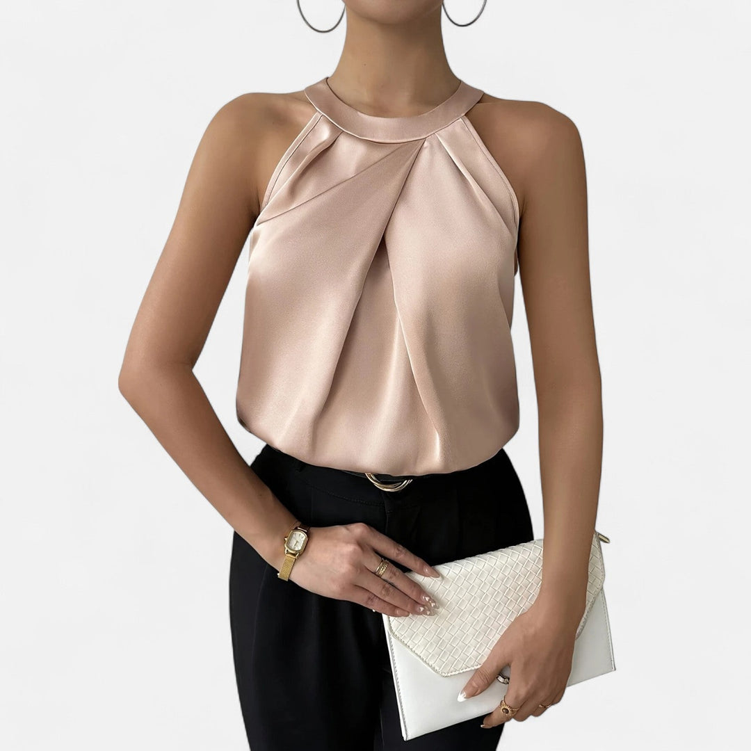 Chic sleeveless women's top featuring elegant drapes and soft pleats, ideal for a sophisticated look.