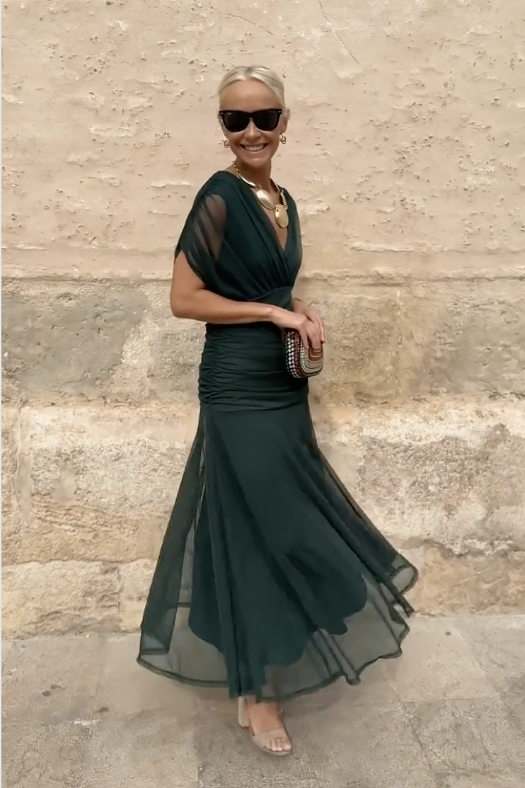 Flowing women's draped maxi dress with elegant V-neckline, ideal for a sophisticated party or evening event.