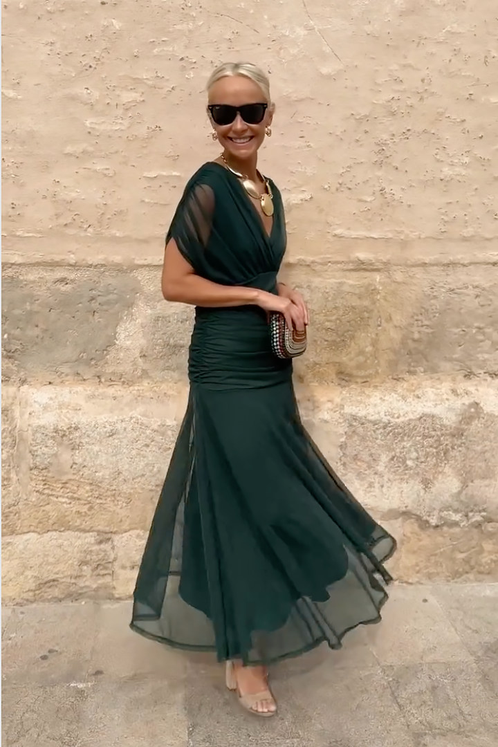 Flowing women's draped maxi dress with elegant V-neckline, ideal for a sophisticated party or evening event.